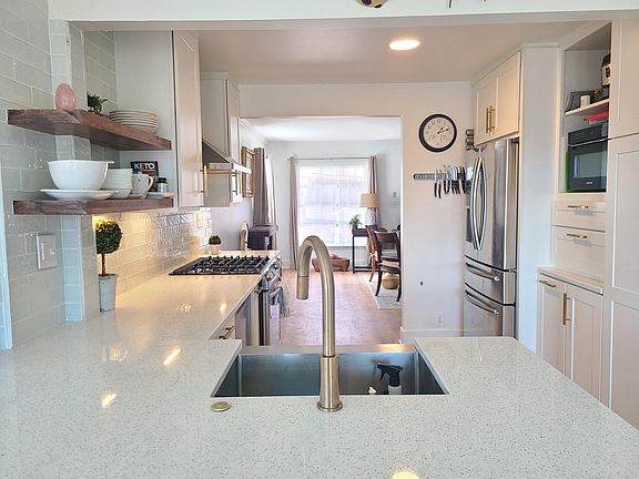 Best views for the washer upper! Open to the dining area in the foreground, and the living area in the far background. Living area leads to bed 2 and another bath, and downstairs has more area to use