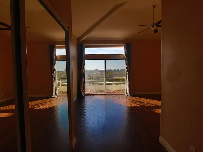 Master bedroom with additional closet and view of the balcony