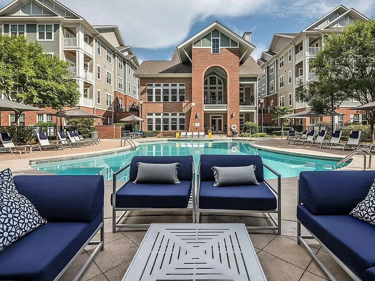 Resort-style pool with lounge seating, sundeck, and upscale clubhouseluxury apartment living in Charlotte.
