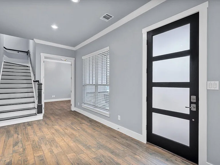 Updated front door and wood stairs with black accents