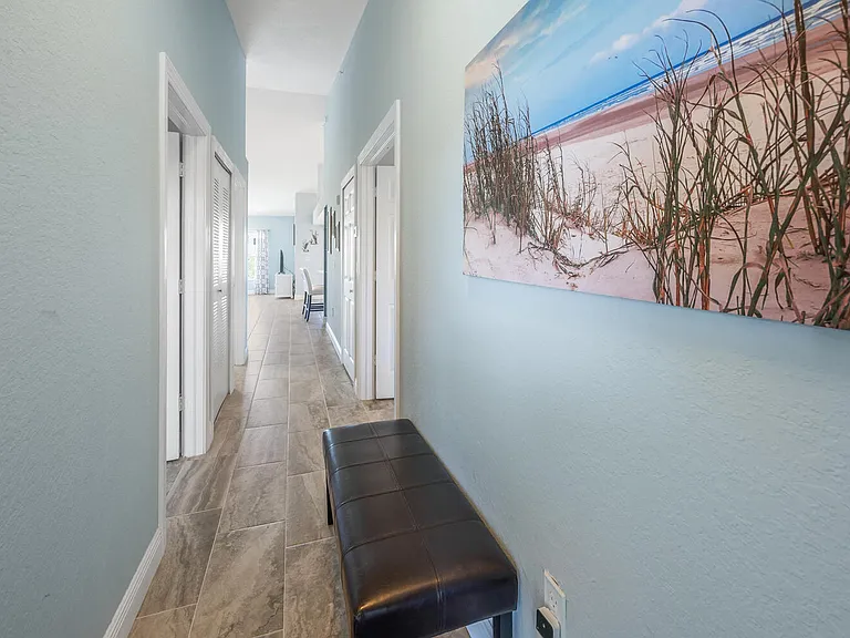 Hallway from front door. Master has double doors on the right. Guest room and hall bath on the left.