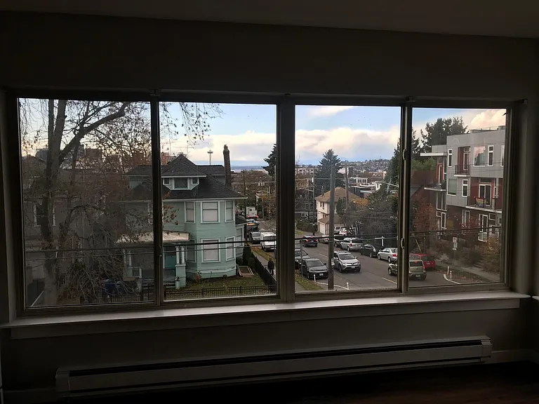 West facing living room window with view of Downtown, Space Needle, Puget Sound, and Olympic mountains