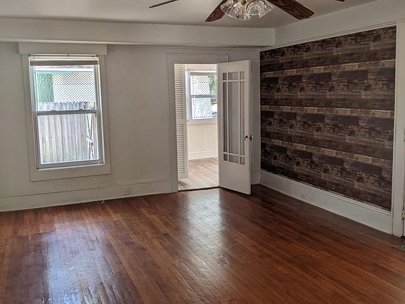 Living room hard wood floors , second bedroom entry.