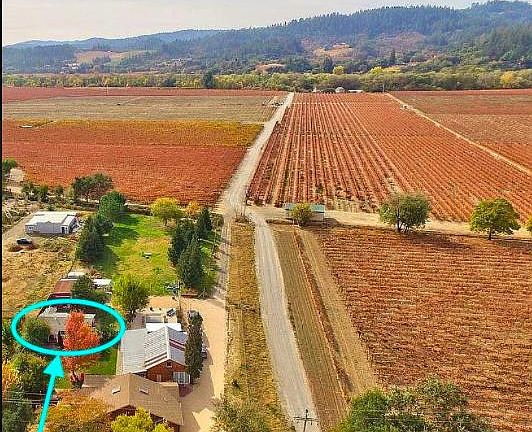 Cottage nestled on 1.5 acre property surrounded by vineyards with another home and barn.