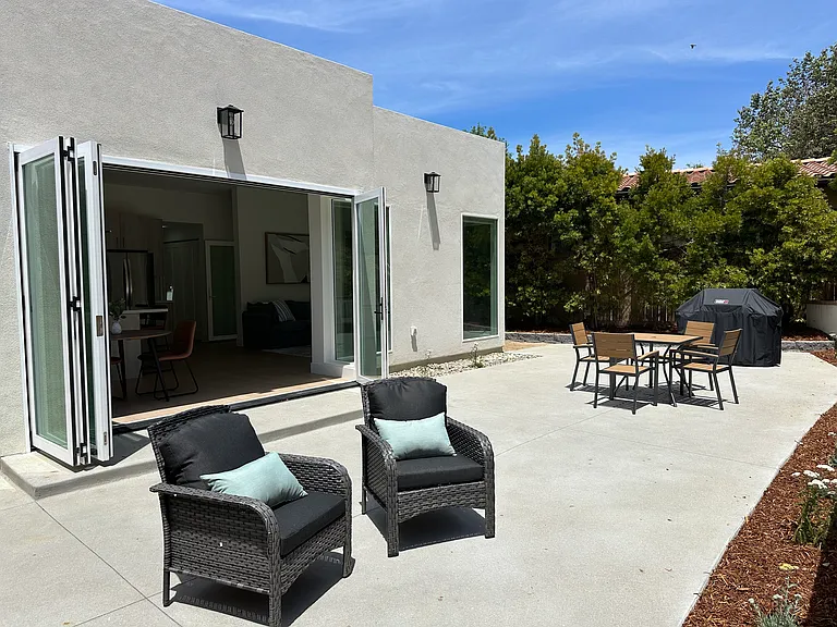 Outdoor patio with gas gill, dining table and chairs