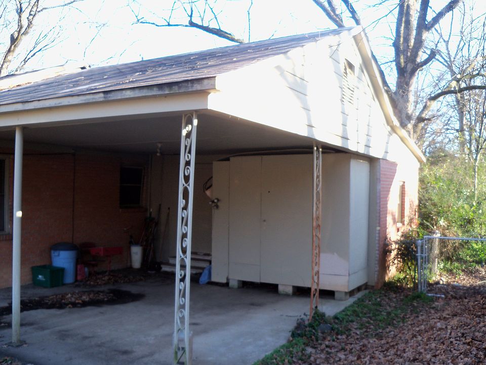 left side of home and carport view, storage cabinet under carport