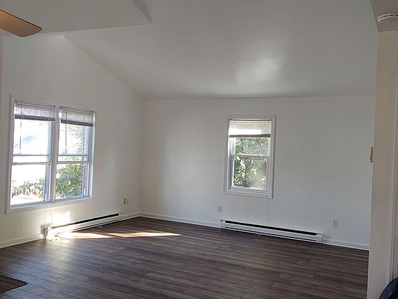 Vaulted ceiling in living room & dining area with brand new flooring
