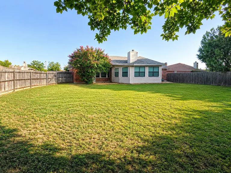 Shaded backyard, perfect for a relaxing break between video calls.