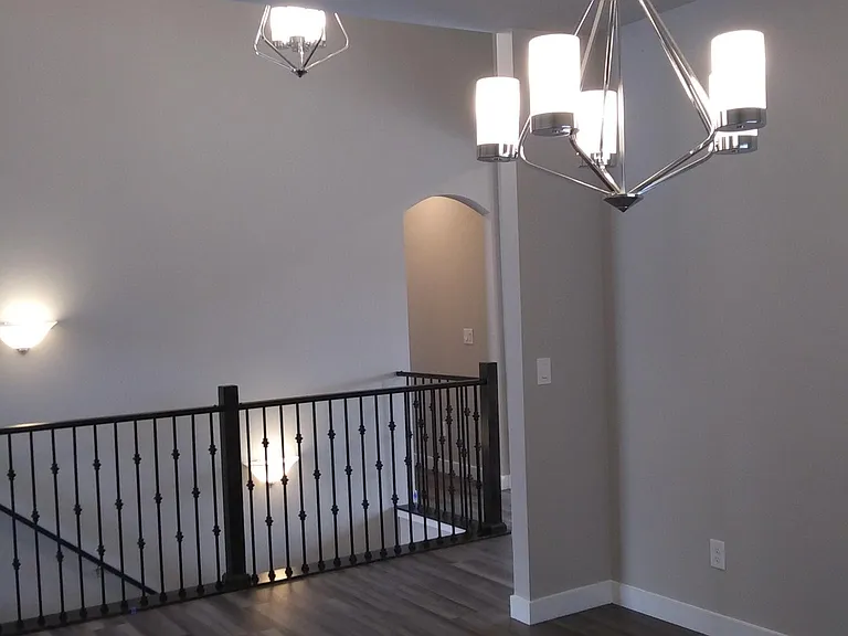 Looking out the Dining Room across the breezeway to stairway and arched-opening to Master Suite hallway.
