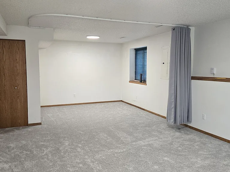basement greatroom. Curtain provided to segment room if interested in privacy or creating 4th bedroom
