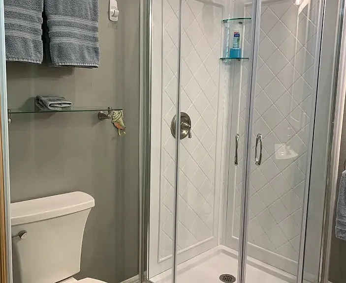 Full size bathroom with towels and toiletries furnished