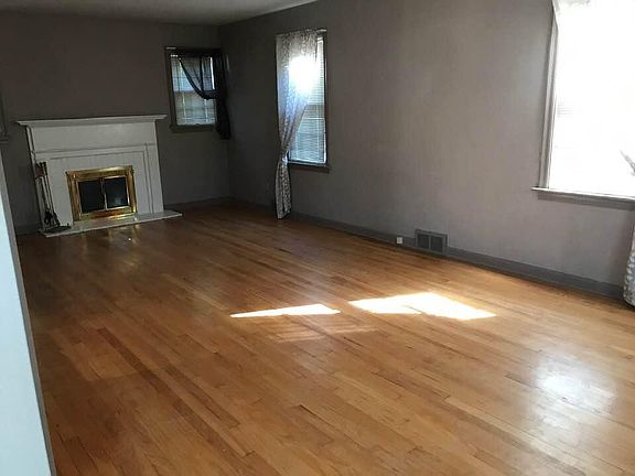 Another View of Living Room with Hardwood floors and Wood burning Fireplace