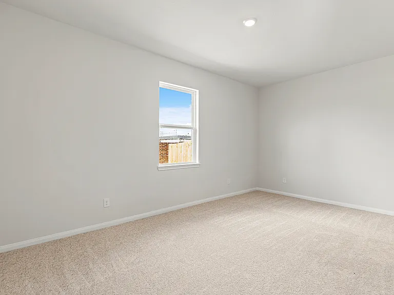 The master bedroom with lush carpet flooring.