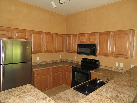 Spacious kitchen with bar that seats four.