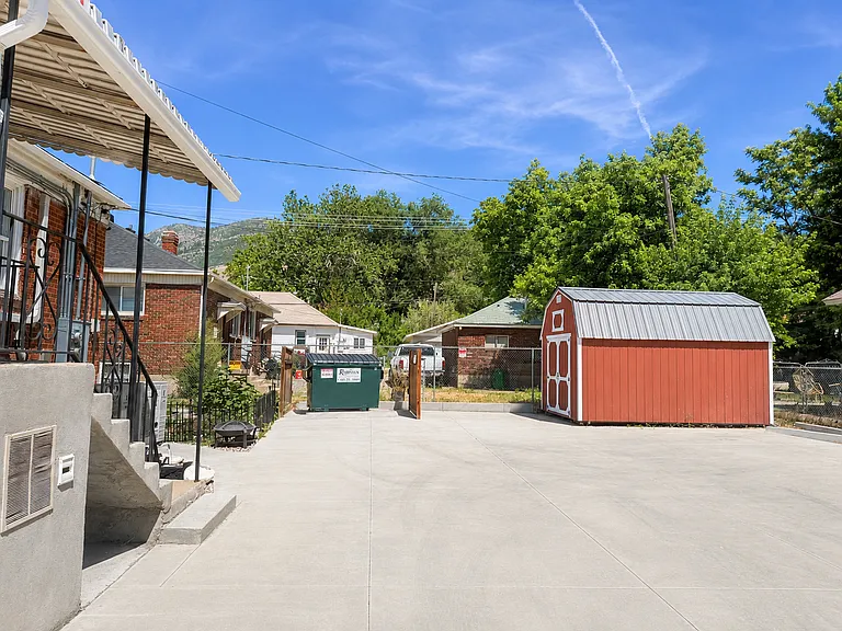 Large private storage shed and additional parking area.