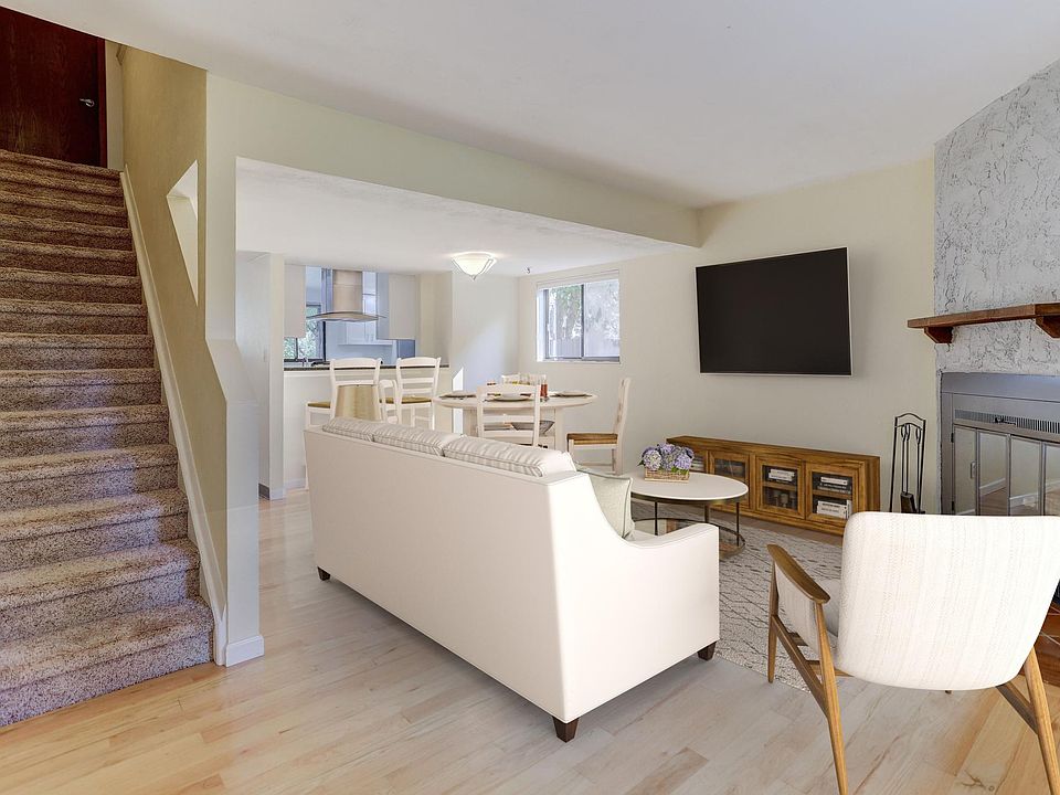 Virtually staged living room - Traditional log fireplace - Southeast facing corner unit with two extra east facing windows