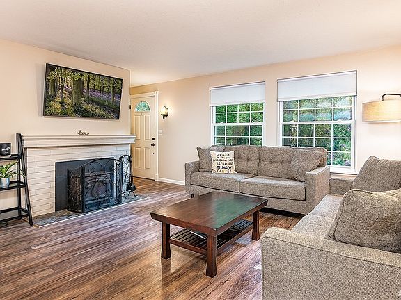 The spacious living living with a wood burning fireplace