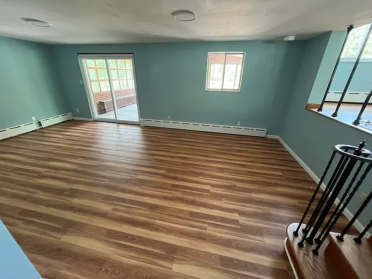 Family room with sliding door access to enclosed porch room.