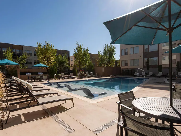 Private Courtyard Featuring Swimming Pool, Loungers, and Shade Umbrellas