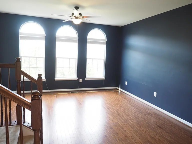 The living room is painted an elegant deep blue.
