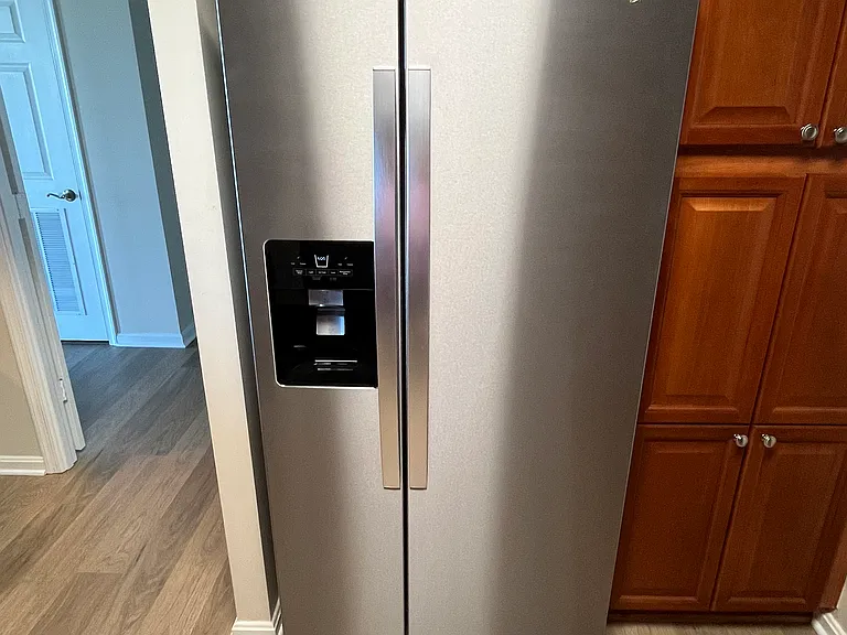 New side-by-side refrigerator / freezer with water & ice dispenser in the door
