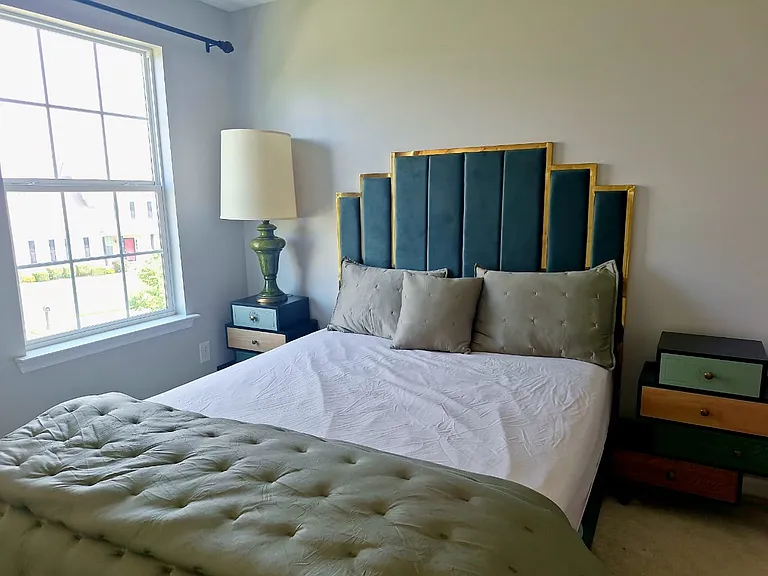 The private primary bedroom offers a peaceful retreat with a king bed and comfortable furnishings for extended stays.