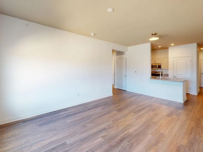 The living room in The Pyle is part of an open-concept floor plan that opens into the modern kitchen. The living room in The Pyle is part of an open-concept floor plan that opens into the modern kitchen.