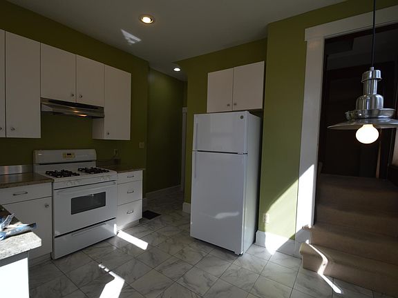 Kitchen with gas range, Bosch dishwasher, and plentiful storage with eating nook and access to the patio/deck.