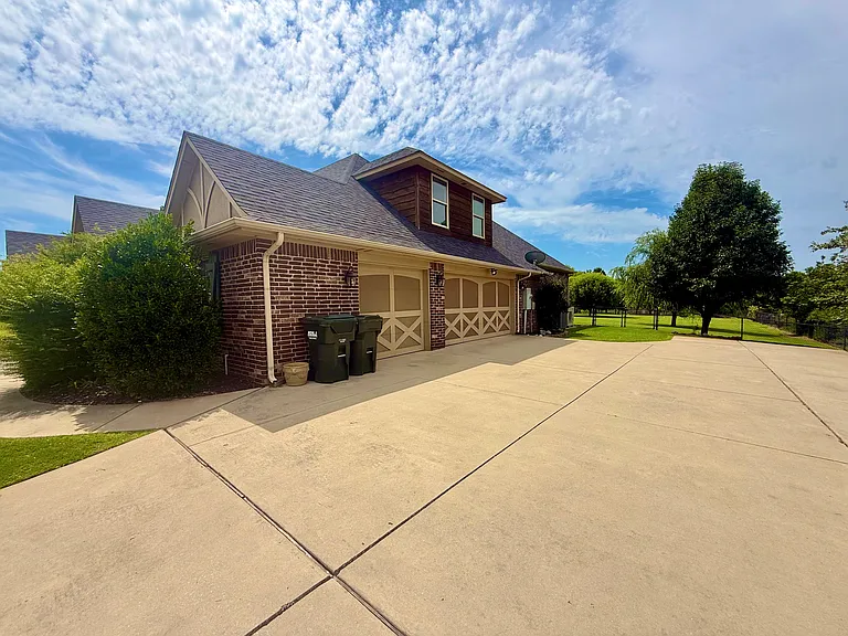 3 car garage with garage door openers. Accessibility through the doors with codes or clickers. 2nd story just above the garage. 

Looking at the big tree, (I planted), look to the left is a double gate for accessibility to the backyard.