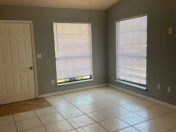 Living room with 2 great size windows and the front door.
