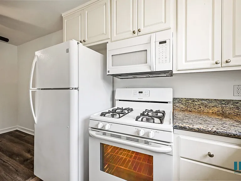 Kitchen with Refrigerator, Stove, and Microwave Oven