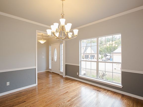 Large formal dining room with new updated light fixture and new interior paint in designer colors