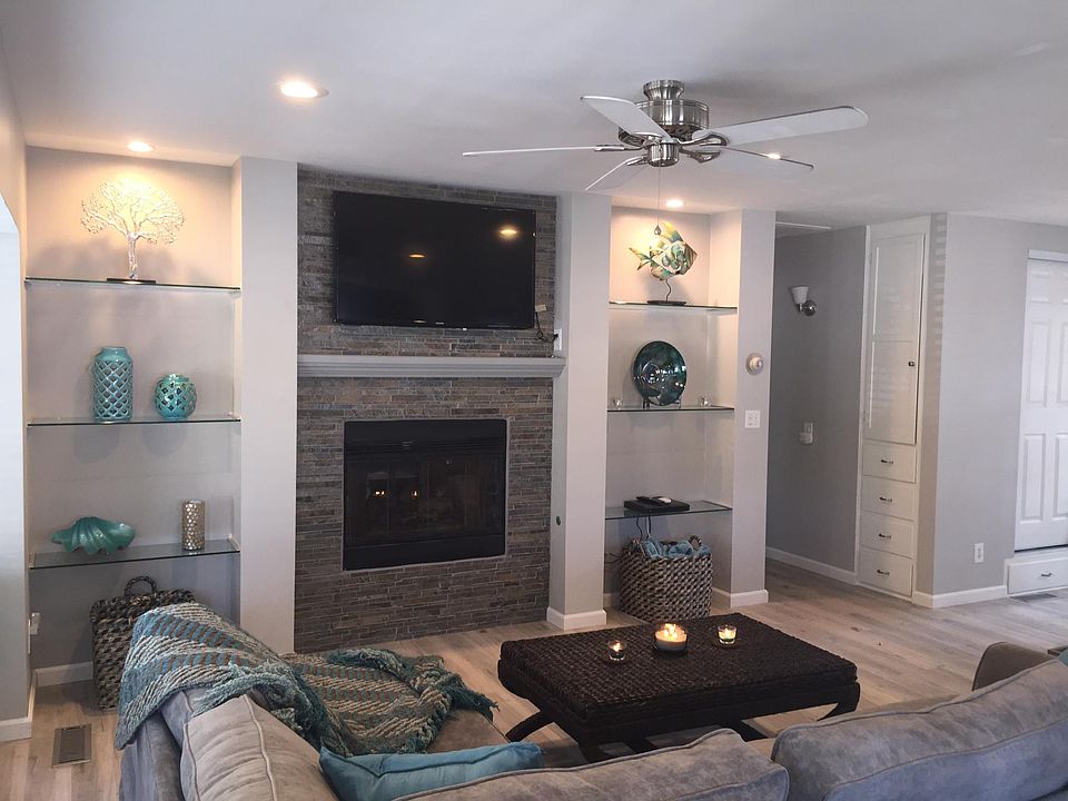 Living room with gas fireplace and 50" smart TV and sofa bed