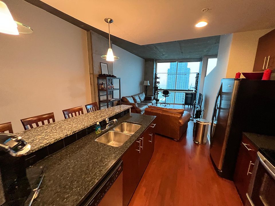 Kitchen looking into living room. (Furnished view.)