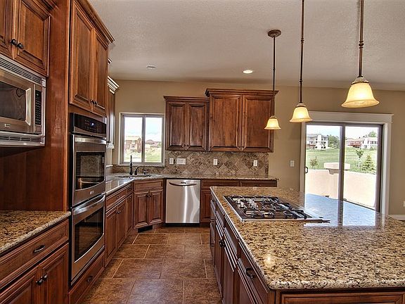 Knotty alder cabinets & stainless steel appliances in kitchen