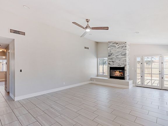 Living Room with ceiling fan and tiled fireplace