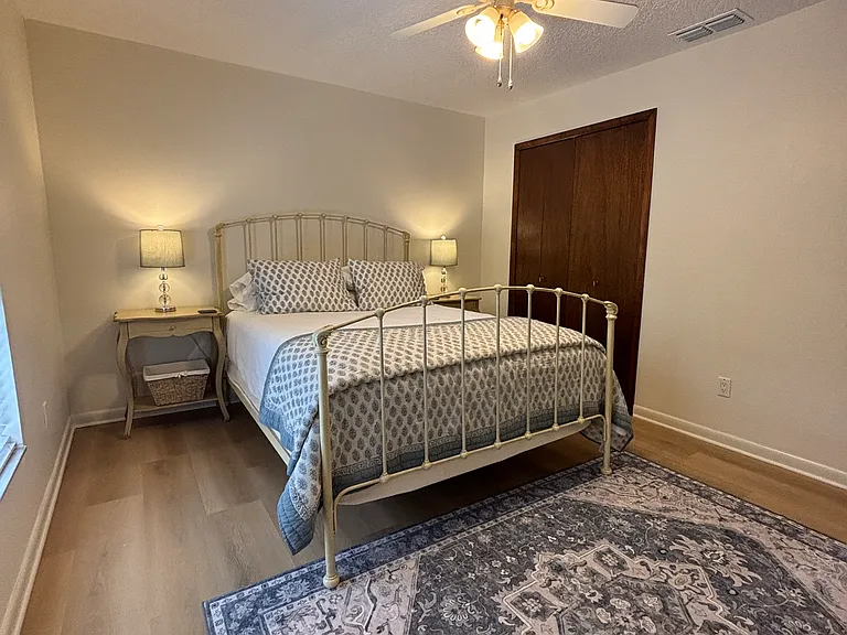 Queen bed, two bed side tables with storage and closet.