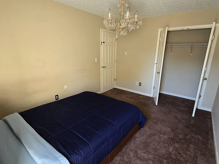 Cozy room with closet space. Bed frame includes additional storage.
