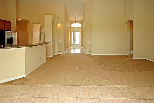 Large family room with french doors leading to pool area