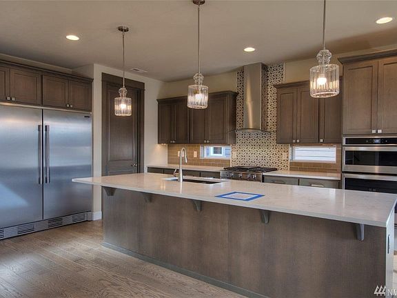 This gorgeous kitchen comes complete with double ovens, under counter and baseboard lighting, and a HUGE double refrigerator! 