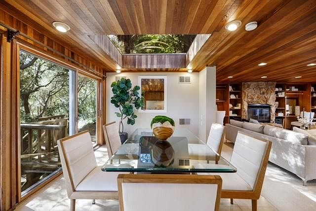 View taken from the kitchen sink area with the forest view on the left and the living area on the right