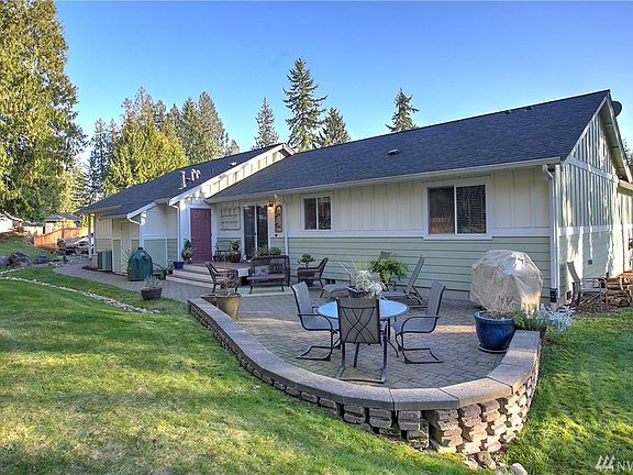 Private backyard patio with stone walkway and entertaining area.