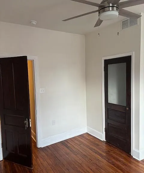 Inside front bedroom with ceiling fan, looking toward hallway. Closet door is on right.