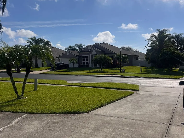 Open driveway with view of landscaped front lawn.