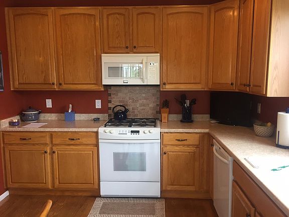 kitchen with gas range, microwave and refrigerator