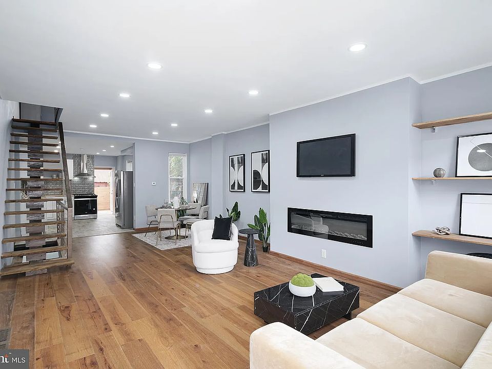 Entrance into the living room (first floor open space) fireplace to the right staircase to the second floor to the left, kitchen, utility room, and the backyard straight ahead. Pristine high quality laminate flooring in the living and dining areas.