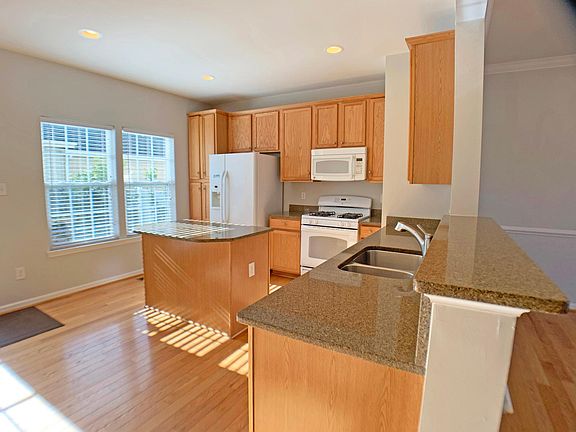 Granite countertops and under-mount stainless steel sink make for a fresh modern look