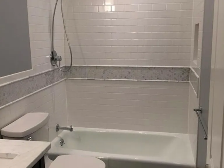 3rd full bath downstairs with marble tile