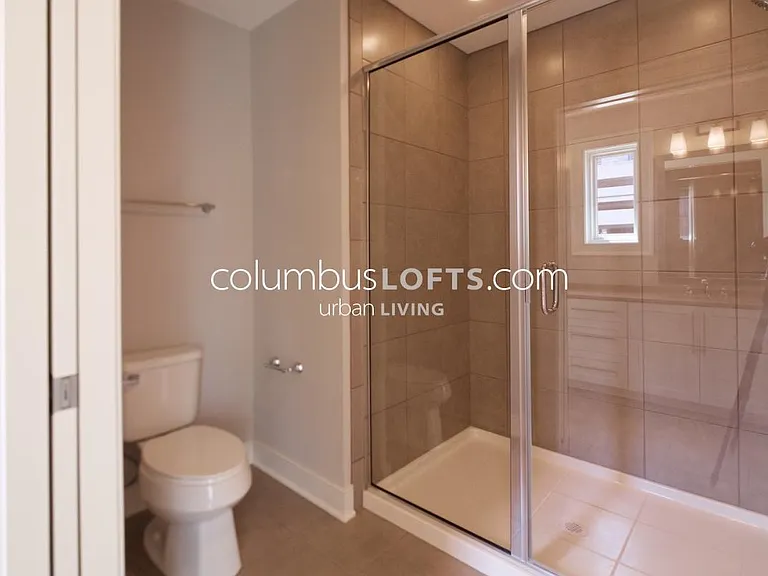 Jack-and-Jill full bathroom in between the 2 upstairs bedrooms connects the 2 bedrooms to one another in between them, features dual vanity sink and separate room with large walk-in shower and toilet (to right in this pic) which pocket door for privacy.