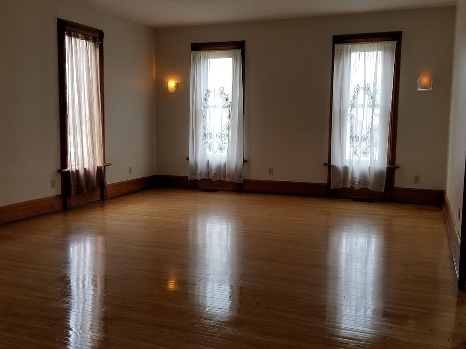 Living room, redone maple floor, wooden blinds on the bay wi